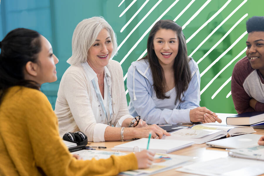 A group of people talking and smiling in a meeting